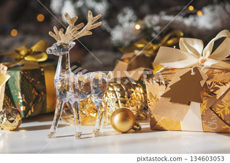Crystal Reindeer with Gold Antlers and Christmas Gifts in Festive Interior Crystal Reindeer with Gold Antlers and Christmas Gifts in Festive Interior 134603053