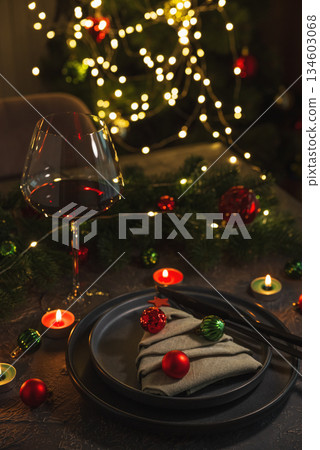 Christmas Table Setting with Tree-Shaped Napkin and Tealight Candles against Christmas lights Christmas Table Setting with Tree-Shaped Napkin and Tealight Candles against Christmas lights 134603068