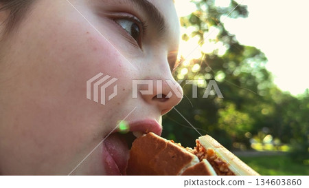 Sunset snacking, leafy background, content child, big sandwich, striped fashion, eating outside, glowing sun, nature all around, relaxed mood, yummy meal, Childhood joy, green park scene, burger Sunset snacking, leafy background, content child, big sandwich, striped fashion, eating outside, glowing sun, nature all around, relaxed mood, yummy meal, Childhood joy, green park scene, burger 134603860