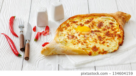Adjarian Khachapuri with egg yolk and cheese Adjarian Khachapuri with egg yolk and cheese 134604159