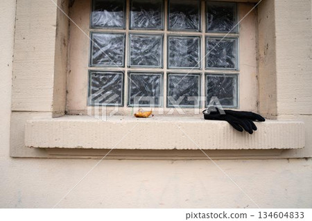 Black gloves on public bathroom window sill Black gloves on public bathroom window sill 134604833