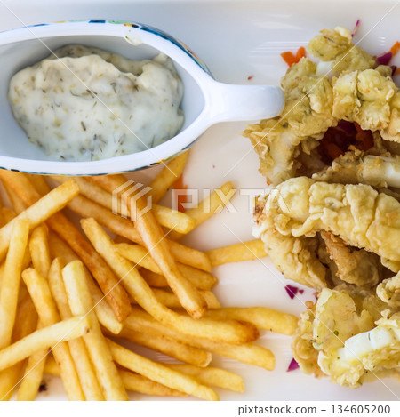 Shrimp in batter, French fries, and creamy garlic sauce Shrimp in batter, French fries, and creamy garlic sauce 134605200