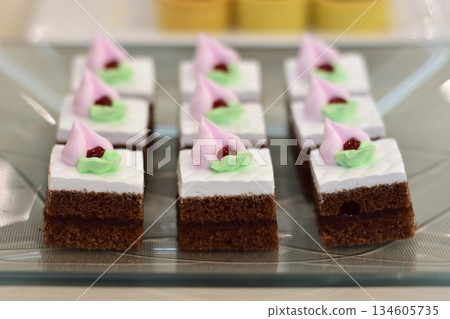 Decorative chocolate cakes with pink frosting Decorative chocolate cakes with pink frosting 134605735