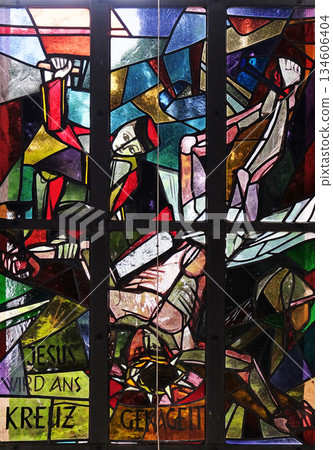 11th Stations of the Cross, Crucifixion: Jesus is nailed to the cross, stained glass window in Saint Lawrence church in Kleinostheim, Germany 134606404