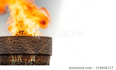 Close-up of a large, ornate torch with a vibrant flame burning brightly against a soft background 134606717