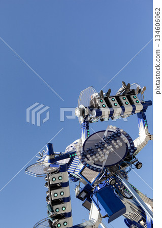 Funfair attraction and blue sky at the amusement park 134606962