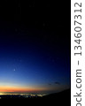 Orion, city lights, and three planets before dawn in summer 134607312