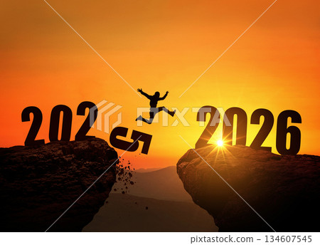 Man jumping on cliff 2026 over the precipice with stones at amazing sunset. New Year's concept. 2025 falls into the abyss. Welcome 2026. People enters the year 2026, creative idea. Man jumping on cliff 2026 over the precipice with stones at amazing sunset. New Year's concept. 2025 falls into the abyss. Welcome 2026. People enters the year 2026, creative idea. 134607545