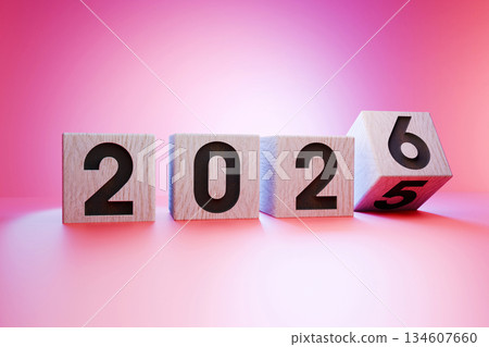 Wooden cubes with numbers forming 2026, symbolizing the upcoming new year, transition from 2025 to 2026, on a pink blue gradient, concept of future and celebration. 2025 flips to 2026, creative idea 134607660