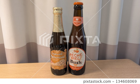 Peach beers in the bottle on the table Peach beers in the bottle on the table 134608069