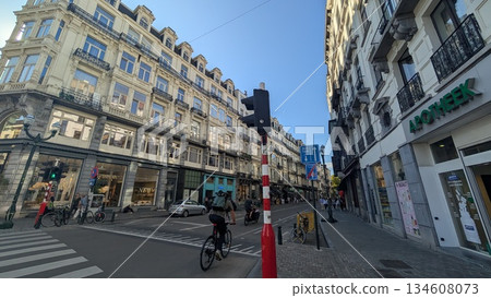 A narrow road with side walk and shops in the city 134608073