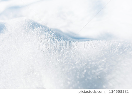detailed macro view of pristine winter snow, shimmering with tiny ice crystals. Gentle curves and bright light reveal the natural texture and purity of a cold, peaceful landscape. Winter holidays detailed macro view of pristine winter snow, shimmering with tiny ice crystals. Gentle curves and bright light reveal the natural texture and purity of a cold, peaceful landscape. Winter holidays 134608381