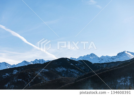 Iconic winter landscape of the Tatra Mountains towering over the popular Zakopane ski resort in Poland. Perfect scenery for skiing, travel, and holidays. 134608391