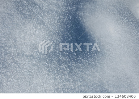 Macro view of pure snow crystals under bright light. A detailed, shimmering winter texture for serene, abstract, or holiday backgrounds. Holidays snowy winter background Macro view of pure snow crystals under bright light. A detailed, shimmering winter texture for serene, abstract, or holiday backgrounds. Holidays snowy winter background 134608406