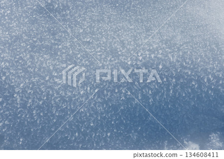 Amazing snow texture, top view. Abstract winter pattern: Close-up of icy granules. Cool-toned, high-key texture with a shimmering effect, perfect for nature and season concepts 134608411