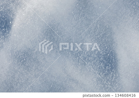 Macro view of frozen snow surface. Abstract winter background with white and light blue ice crystals, ideal for seasonal wallpapers and holiday cards. Snow holidays winter background. Macro view of frozen snow surface. Abstract winter background with white and light blue ice crystals, ideal for seasonal wallpapers and holiday cards. Snow holidays winter background. 134608416