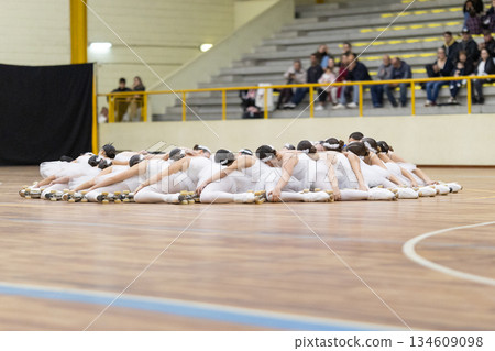 Group of roller skaters performing artistic choreography 134609098