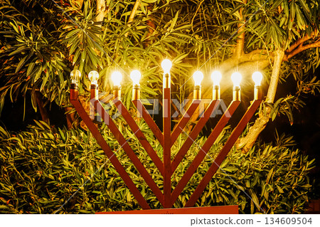 Hanukkah Candles Lit Outdoors at Evening Hanukkah Candles Lit Outdoors at Evening 134609504