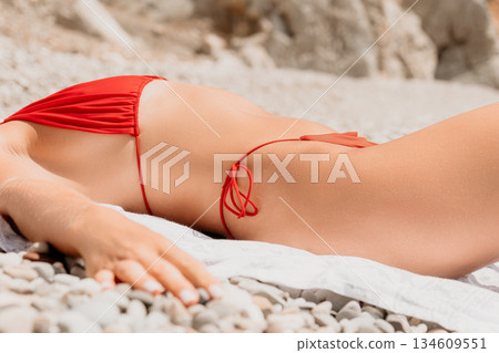 Bikini Beach Sunbathing Woman Relaxing on Pebble Beach 134609551