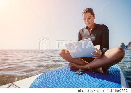 Woman Laptop Paddleboard Ocean Work Remotely 134609552