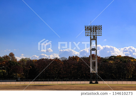 Stadium lights pole against blue sky, daytime. 134610273