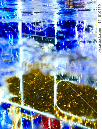 Reflection of night city lights on wet pavement Reflection of night city lights on wet pavement 134610589