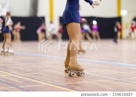 Young figure skater roller skating practice in stadium Young figure skater roller skating practice in stadium 134610887