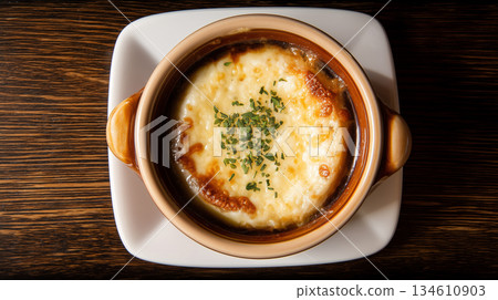 French Onion Soup with Melted Cheese in Brown Crock 134610903
