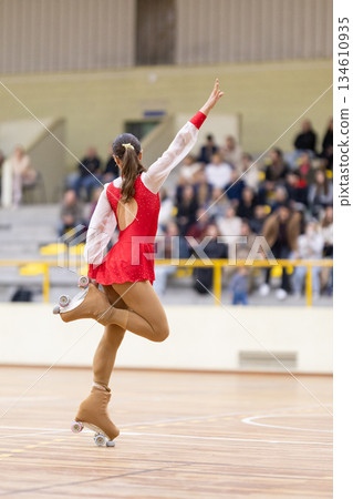 Female roller skater balancing on one leg performing artistic routine Female roller skater balancing on one leg performing artistic routine 134610935