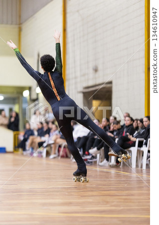 Artistic roller skater balancing during a performance Artistic roller skater balancing during a performance 134610947