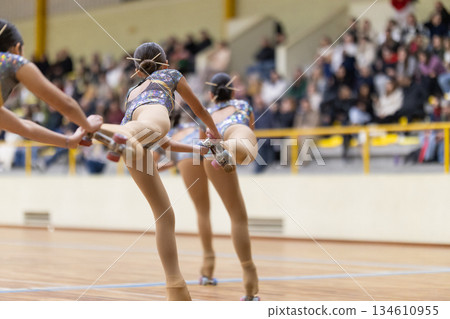 Female roller skaters performing artistic skating routine 134610955