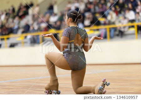 Young girl roller skating performing on rink during competition Young girl roller skating performing on rink during competition 134610957