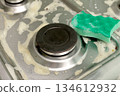 Cleaning the stovetop with a sponge and soapy water. Home cleaning concept 134612932