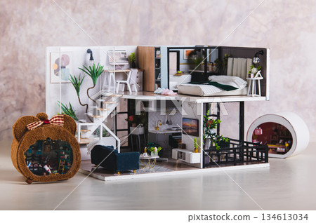 A miniature tiny replica of a residential house made by hand on a table A miniature tiny replica of a residential house made by hand on a table 134613034