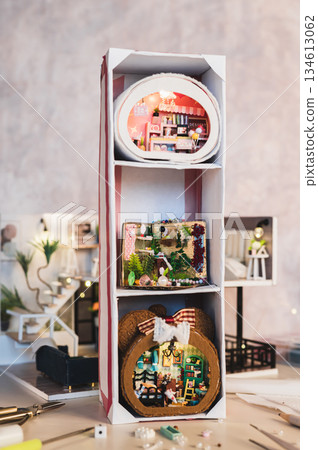 Three tiny miniature roomboxes in a vertical rack Three tiny miniature roomboxes in a vertical rack 134613062