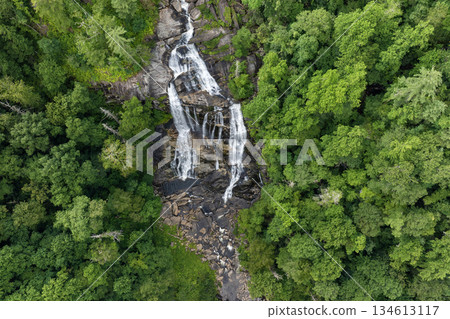 Whitewater Falls with falling down clear water from rocky boulders between green lush woods in Nantahala National Forest, North Carolina, USA Whitewater Falls with falling down clear water from rocky boulders between green lush woods in Nantahala National Forest, North Carolina, USA 134613117