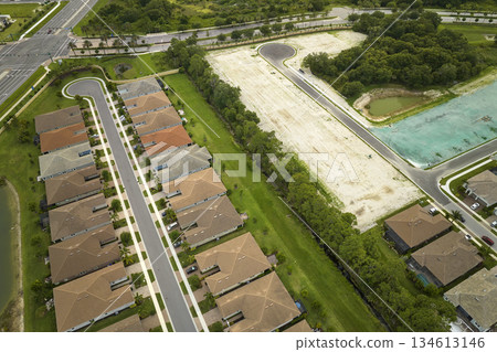 View from above of densely built residential houses under construction in closed living clubs in south Florida. American dream homes as example of real estate development in US suburbs View from above of densely built residential houses under construction in closed living clubs in south Florida. American dream homes as example of real estate development in US suburbs 134613146