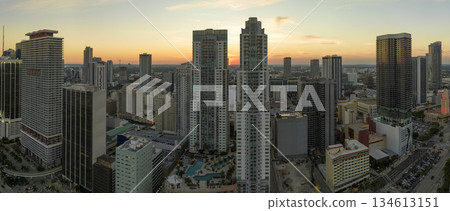 View from above of concrete and glass skyscraper buildings in downtown district of Miami Brickell in Florida, USA at sunset. American megapolis with business financial district at nightfall View from above of concrete and glass skyscraper buildings in downtown district of Miami Brickell in Florida, USA at sunset. American megapolis with business financial district at nightfall 134613151