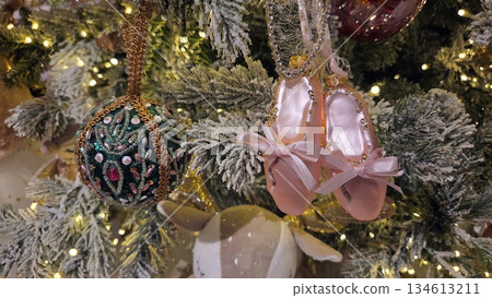 Festive christmas tree with ornaments and ballet slippers for holiday decoration. Horizontal banner. Copy space. For a dance studio or ballet school. Free space for text Festive christmas tree with ornaments and ballet slippers for holiday decoration. Horizontal banner. Copy space. For a dance studio or ballet school. Free space for text 134613211