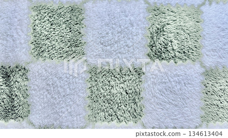 shaggy checkerboard rug texture in mint green and white fuzzy squares closeup for cozy home wallpaper or abstract design background 134613404