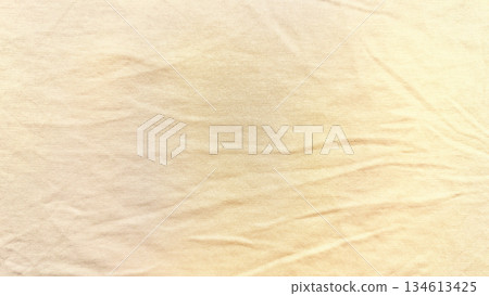 soft wrinkled beige fabric texture closeup gentle folds warm golden hues neutral background wallpaper copy space banner soft wrinkled beige fabric texture closeup gentle folds warm golden hues neutral background wallpaper copy space banner 134613425