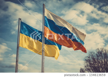 Ukrainian and Russian Flags Fluttering Together in Sunlit Sky 134613659