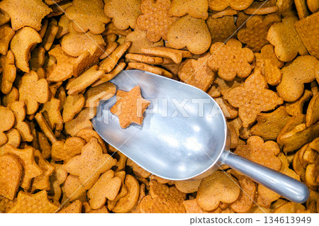 Metal scoop with star-shaped gingerbread cookie among assorted festive holiday biscuits Metal scoop with star-shaped gingerbread cookie among assorted festive holiday biscuits 134613949
