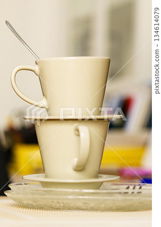 Dirty cups after coffee drinking, messy desk Dirty cups after coffee drinking, messy desk 134614079