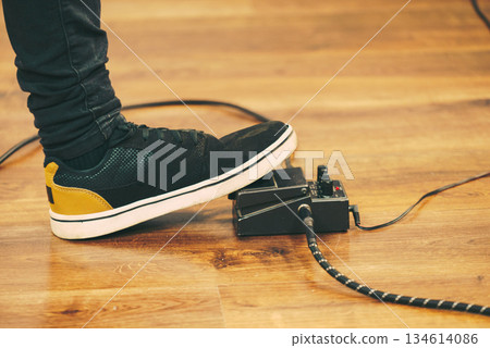 Man using guitar effects pedal Man using guitar effects pedal 134614086