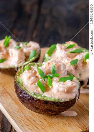 Avocado halves filled with guacamole and shrimp topped with spicy sriracha mayo Avocado halves filled with guacamole and shrimp topped with spicy sriracha mayo 134614100
