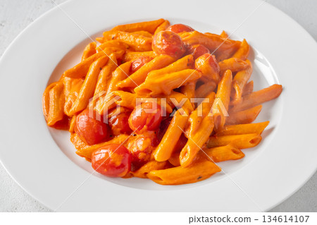 Penne pasta with roasted bell pepper emulsion cherry tomatoes Parmesan and herbs Penne pasta with roasted bell pepper emulsion cherry tomatoes Parmesan and herbs 134614107