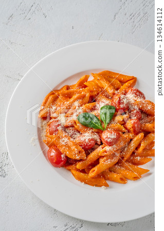 Penne pasta with roasted bell pepper emulsion cherry tomatoes Parmesan and herbs Penne pasta with roasted bell pepper emulsion cherry tomatoes Parmesan and herbs 134614112