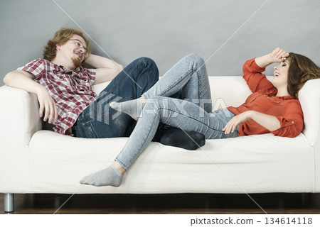 Happy man and woman lying on sofa Happy man and woman lying on sofa 134614118