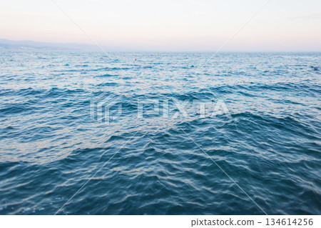 Ocean surface with rippling water patterns in natural light, peaceful seascape for backgrounds or nature themes 134614256